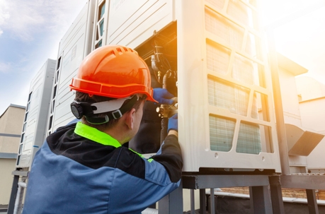 HVAC tecnician checking the unit